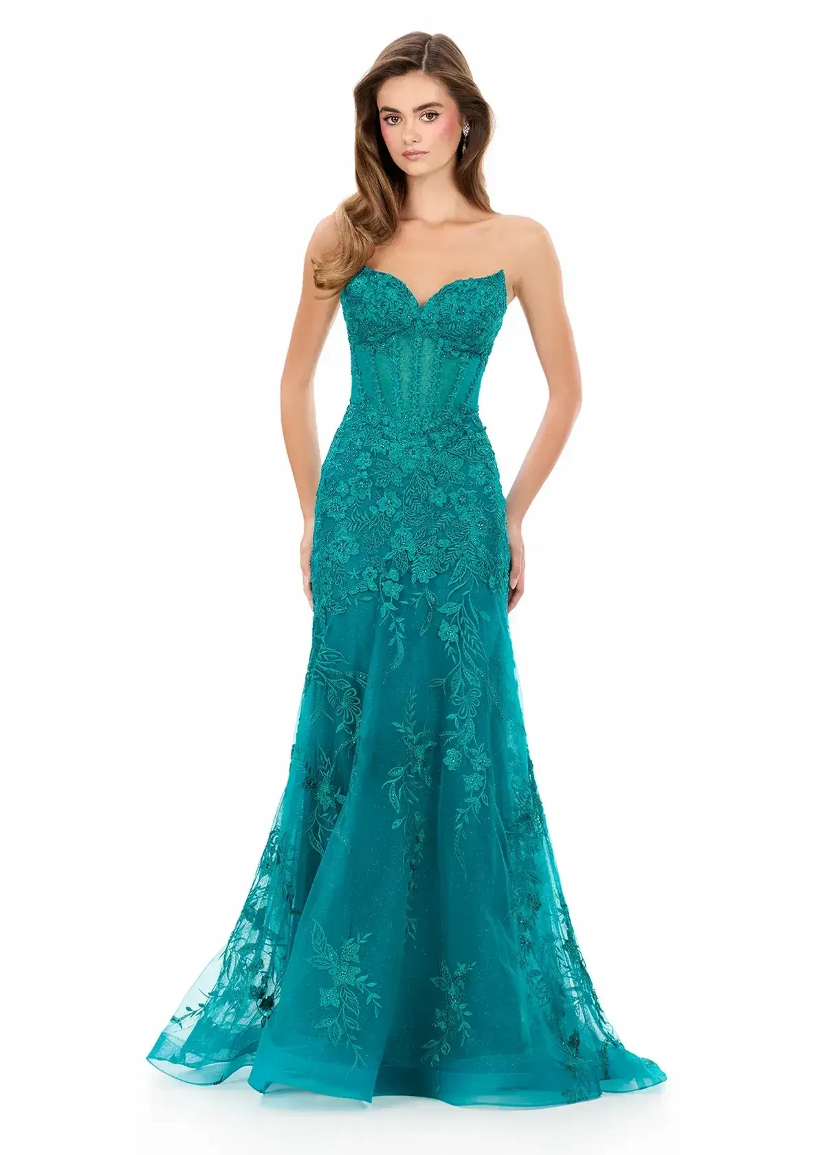 A woman wearing a strapless, teal evening gown with intricate embroidery and a mermaid silhouette.